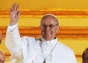 Newly-elected Pope Francis smiles shyly and waves to the crowd.